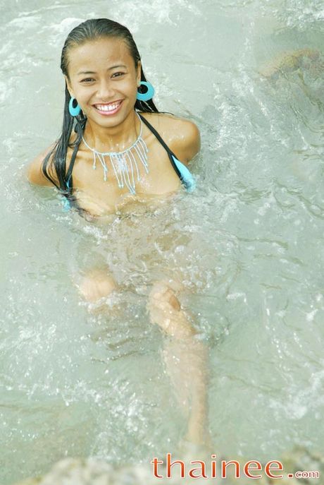Thai teen girl splashes around in the thailand sea