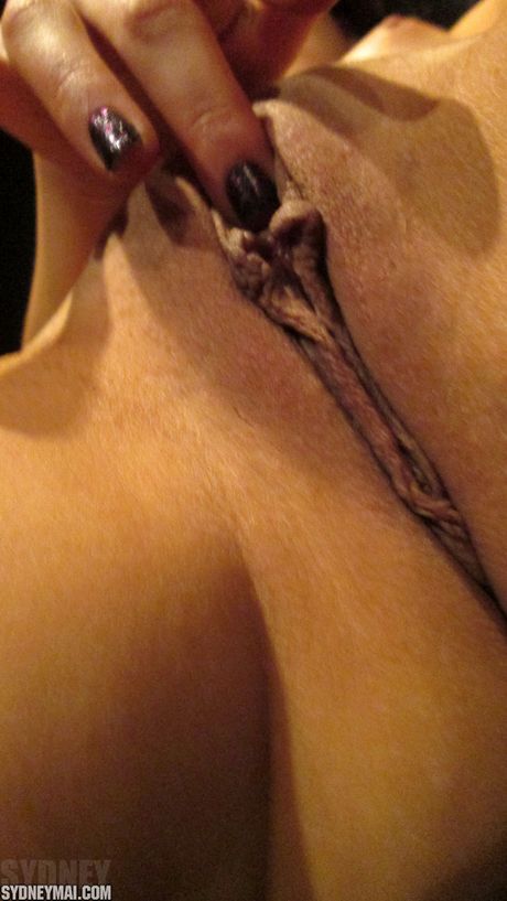 Asian teen Sydney Mai strips and rubs wet twat while masturbating