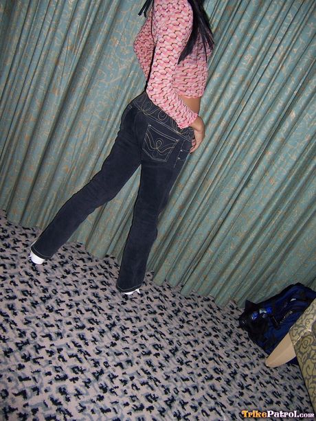 Asian babe Roseanne strips and shows her hot ass and tits in a solo