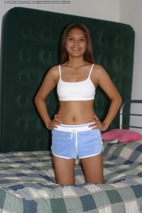 Asian teen Tai Angel strips and shows her hairy pussy up close