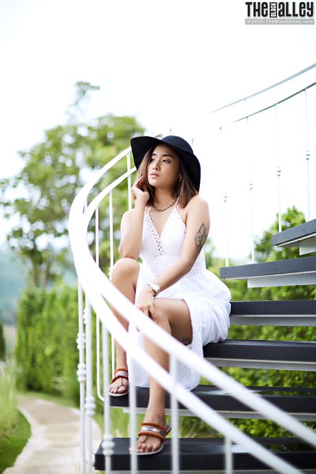 The Asian babe Apple strips and shows her hairy pussy in a solo outdoors